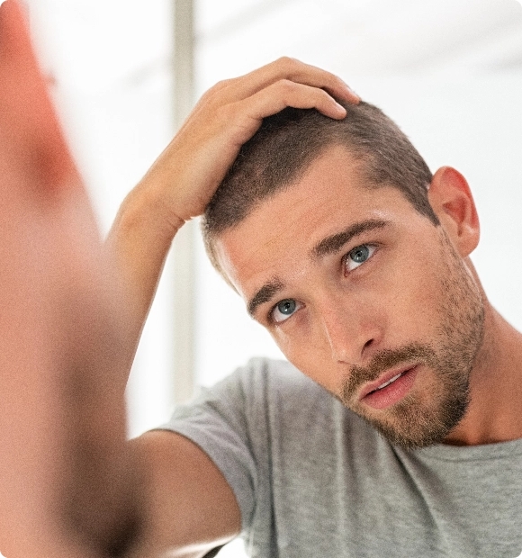 young-man-checking-hair-in-mirror